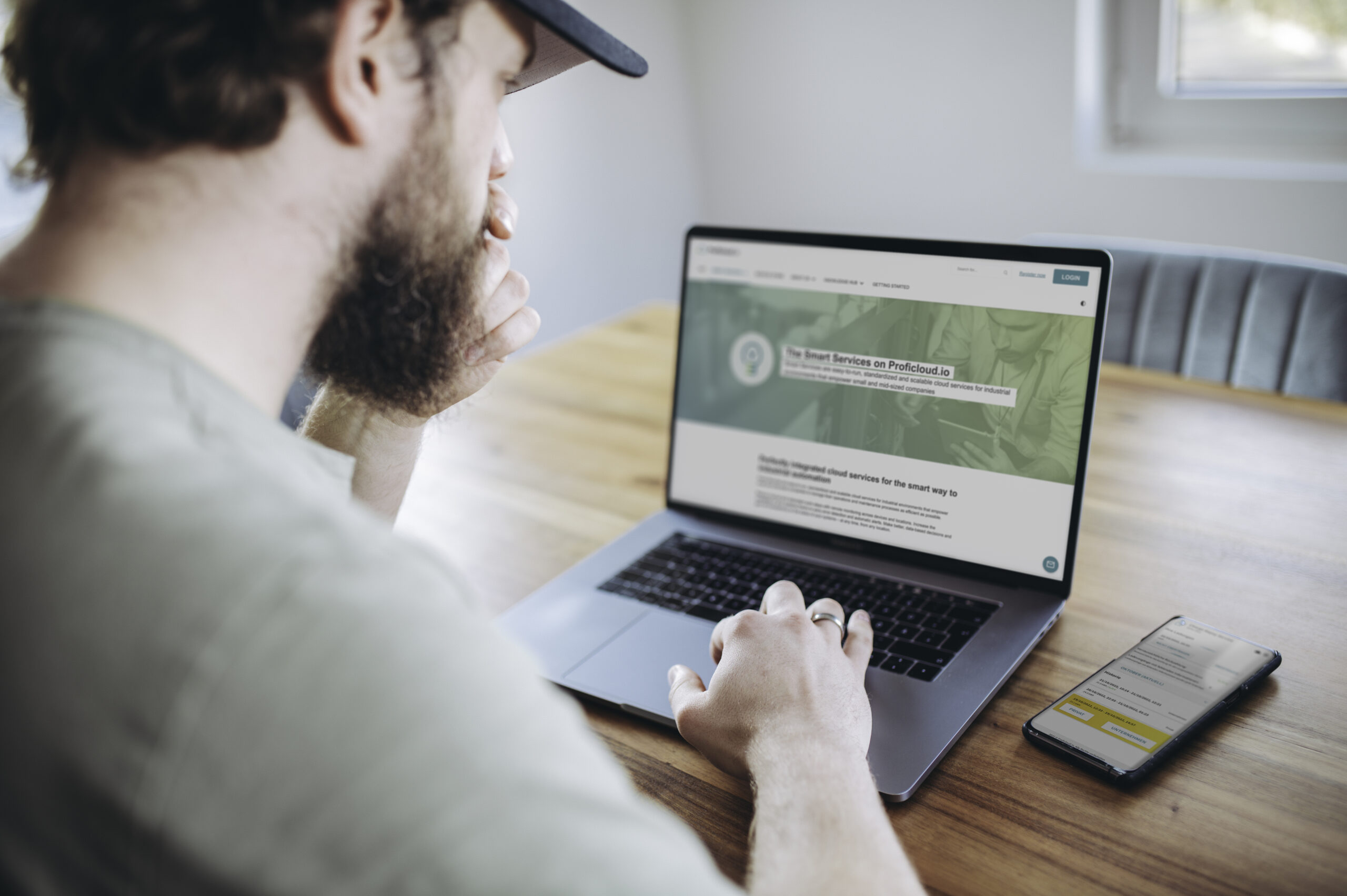 Man using Proficloud on a MacBook Pro in a Living Room